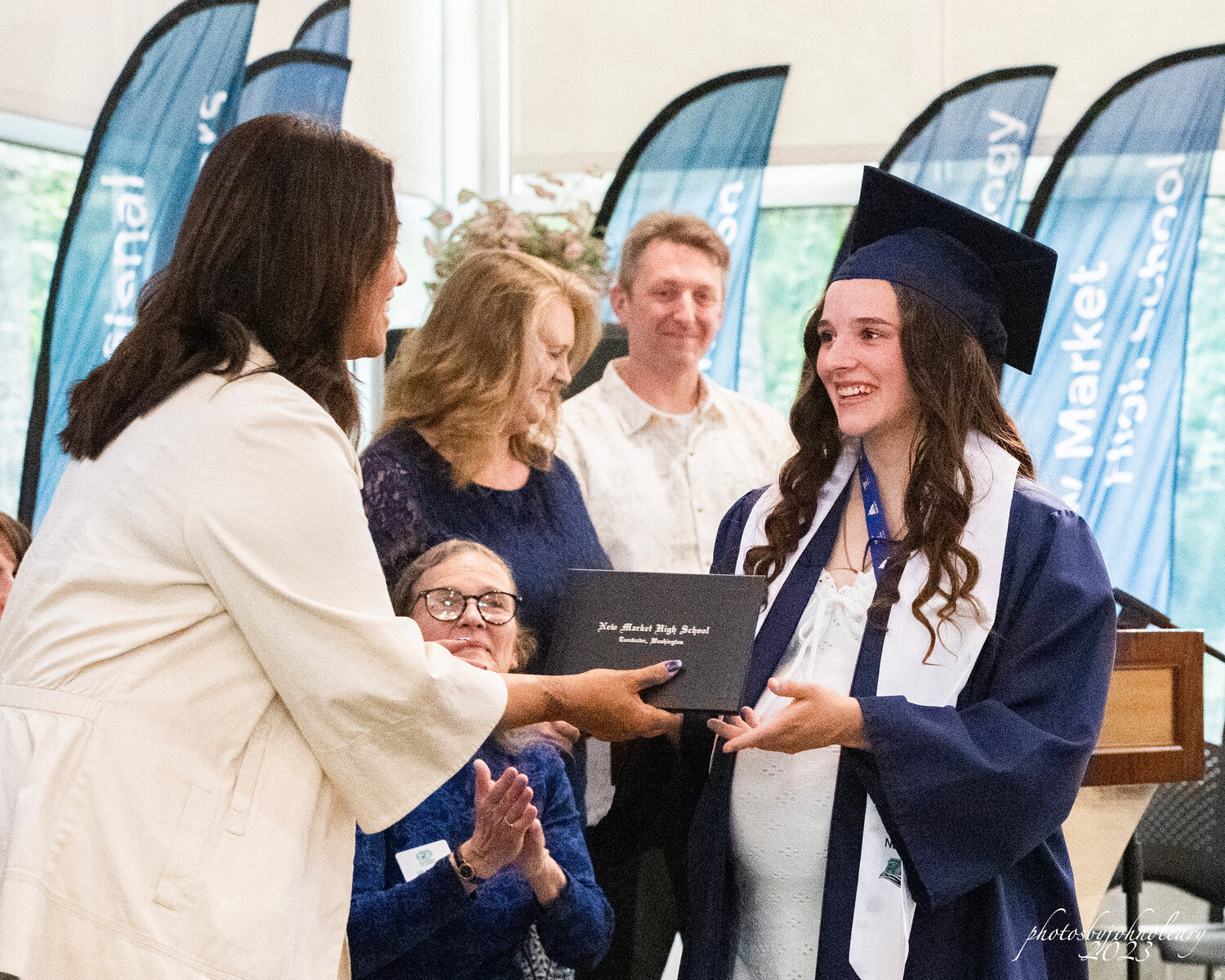 A New Market High School graduate receives her diploma.